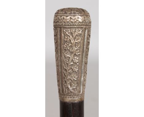 AN INDIAN EBONY WALKING STICK WITH SILVER HANDLE.  35ins long.