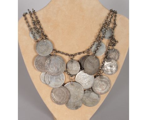 A CHAIN OF ISLAMIC AND OTHER COINS.