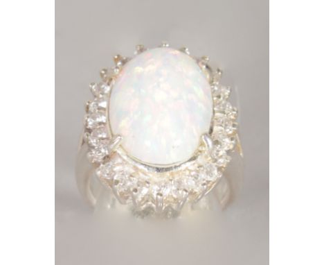 A SILVER, OPAL AND BRILLIANT OVAL CLUSTER RING.