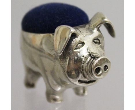 A SILVER NOVELTY PIG PIN CUSHION.