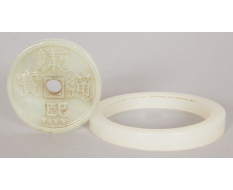 A CHINESE JADE BI DISC, decorated with calligraphy, 1.9in diameter; together with a jade bangle, 2.8in diameter, the inner ri