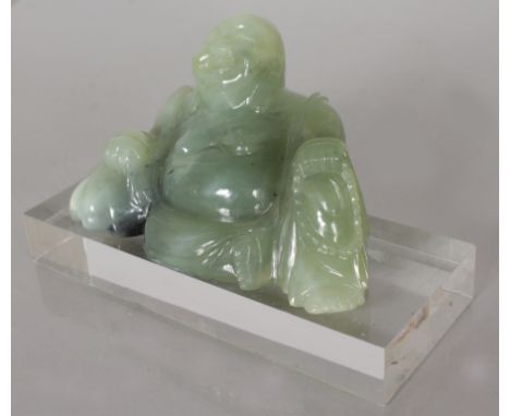 A JADE BUDDHA ON STAND.