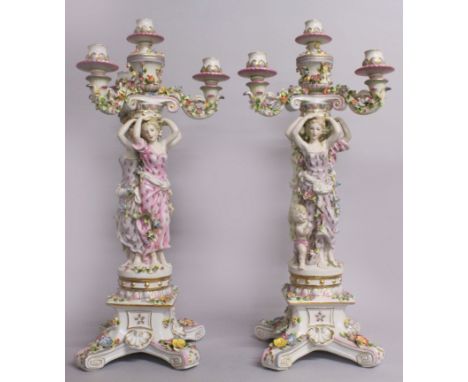 A LARGE PAIR OF "MEISSEN" STYLE THREE LIGHT PORCELAIN CANDELABRA, supported by female figures and cupids, encrusted and paint
