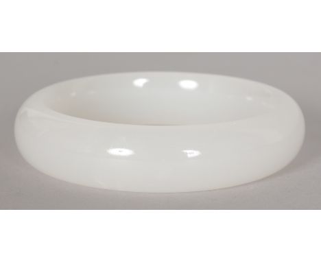 A CHINESE WHITE JADE BANGLE, 2.9in diameter, the inner rim 2.3in diameter.