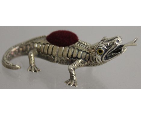 A SILVER NOVELTY LIZARD PIN CUSHION.