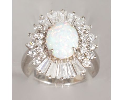 A SILVER, OPAL AND BRILLIANT CLUSTER RING.