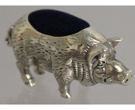 A SILVER NOVELTY PIG PIN CUSHION.