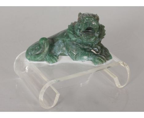 A JADE LION ON STAND.
