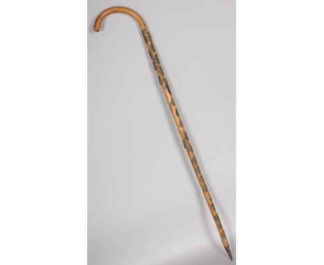 A WALKING STICK with numerous brass plaques of French towns.  36ins long.