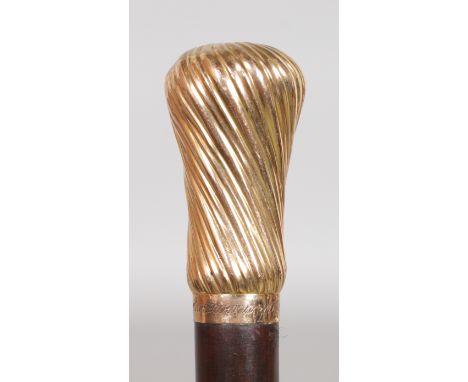 A VERY GOOD GOLD TOPPED SNAKEWOOD CANE. Date: 1870.  Country: English. A good quality pink gold and swirl decorated handle mo