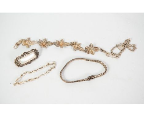 SILVER CURB PATTERN IDENTITY BRACELET; two silver CHAIN BRACELETS; a filigree BRACELET, with floral links and a silver BROOCH