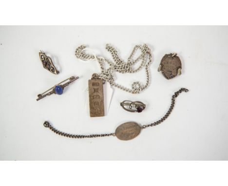 SILVER INGOT PENDANT, Birmingham 1977, on a metal chain NECKLACE; a small silver identity BRACELET; three silver small stone 