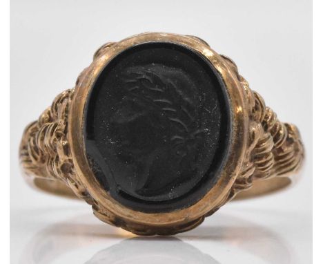 A 9ct yellow gold signet ring with carved intaglio, size W, approx 5.8g.