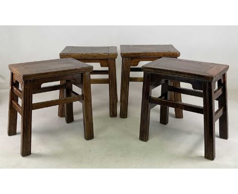 A matched set of four Korean elm occasional tables/stools, the tallest 46 x 41.5 x 33cm, the shortest 43 x 41 x 32cm.