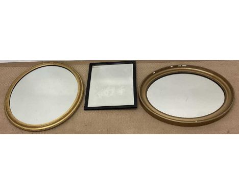 Three mirrors, two oval examples with gilt frames, 60 x 52cm, and a rectangular mirror with bevel edged plate, 40 x 29cm.Cond