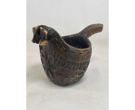 A 19th century Norwegian large carved wooden jug or kovsh with two horse heads in the form of a spout and a carved Nordic pat