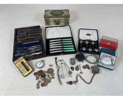 An Edwardian hallmarked silver vesta case, Birmingham 1902, suspended on a yellow metal chain, a pair of silver tongs, a mili