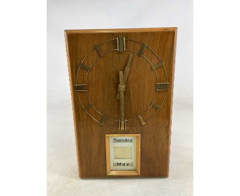 An Art Deco walnut and light oak self-winding automated calendar clock, self-adjusting to the day and month, and with baton m