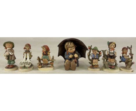 HUMMEL; a collection of seven figures to include a young boy seated holding an umbrella, No.152/08 to the underside.