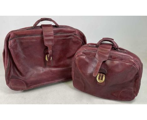 Two vintage burgundy leather suitcases, both embossed Gucci into leather lock protector, one approximately 60 x 80cm, the oth