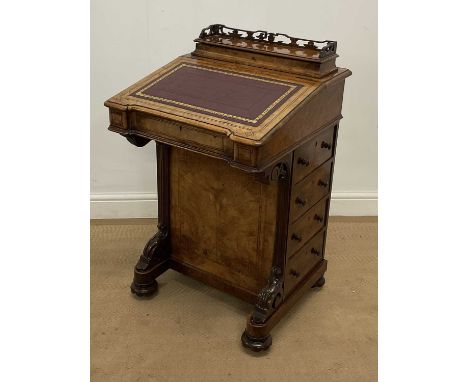 A walnut Davenport, the top with dark red leather insert and with four drawers to one side and faux drawers to the other, hei