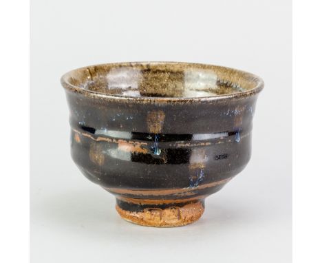 JIM MALONE (born 1946); a stoneware chawan covered in tenmoku breaking to kaki glaze with copper blue streaks, impressed JM a