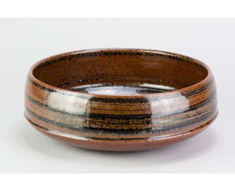 DAVID LLOYD JONES (1928-1994); a large stoneware straight sided bowl covered in tenmoku breaking to kaki glaze, impressed LJ 
