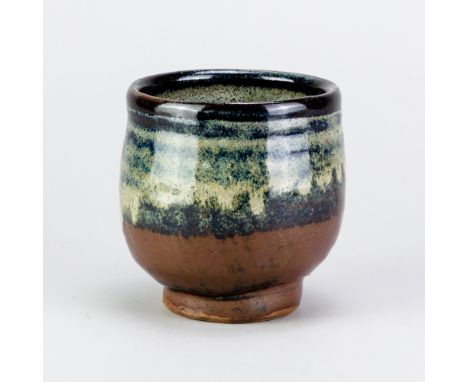 TREVOR CORSER (1938-2015) for Leach Pottery; a stoneware yunomi covered in tenmoku, kaki and nuka glaze, impressed TC and pot