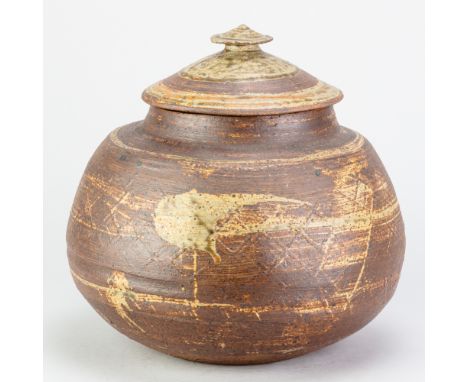 JANET LEACH (1918-1997) for Leach Pottery; a large red stoneware jar and cover partially covered in green ash glaze with padd