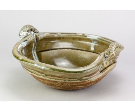 TAKESHI YASUDA (born 1943); a stoneware twin handled 'sprung bottom bowl' covered in green ash glaze with chun pours, impress