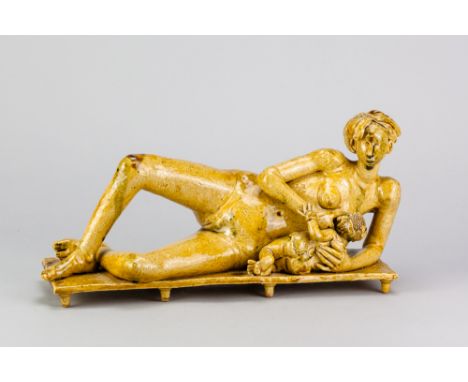 PHILIP EGLIN (born 1959); 'Reclining Nude Giving Suck', an earthenware sculpture covered in yellow lead glaze, length 29cm, h