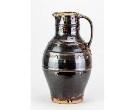 JIM MALONE (born 1946); a very large stoneware baluster jug covered in tenmoku breaking to kaki glaze with impressed decorati