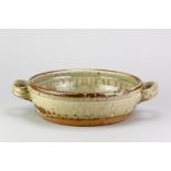 RICHARD BATTERHAM (1936-2021); a large stoneware twin handled pan covered in green ash and kaki