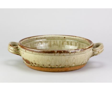 RICHARD BATTERHAM (1936-2021); a large stoneware twin handled pan covered in green ash and kaki glaze with chatter marks to t