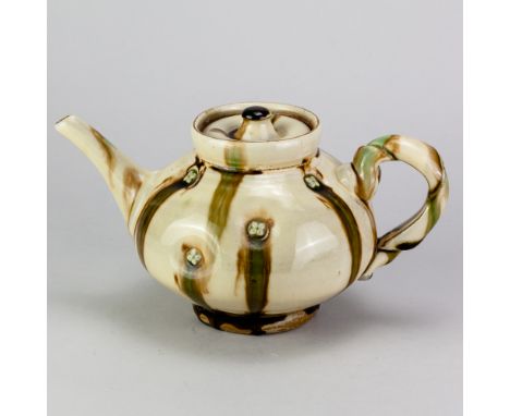 TAKESHI YASUDA (born 1943); a stoneware teapot covered in sansai glaze with impressed button decoration, impressed mark, heig