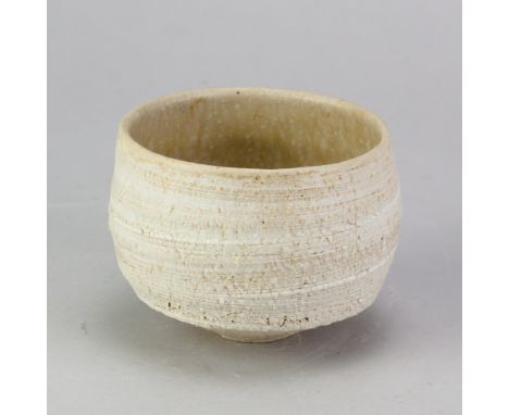 YOSHIMI FUTAMURA (born 1959); a small stoneware chawan with textured exterior covered in white glaze and oatmeal interior, in