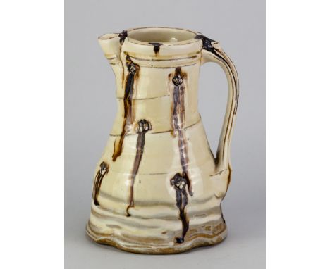 TAKESHI YASUDA (born 1943); a stoneware pitcher covered in nisai glaze with impressed button decoration, impressed mark (glaz
