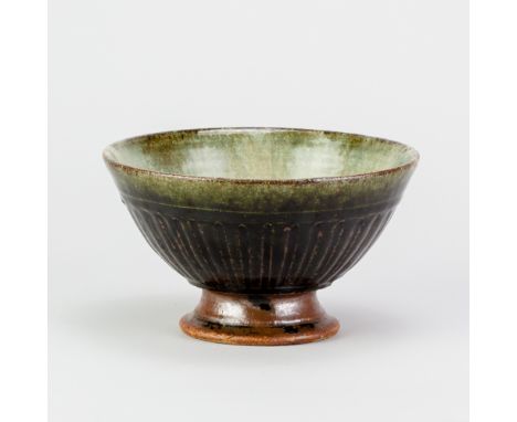 RICHARD BATTERHAM (1936-2021); a stoneware fluted tazza covered in green ash and tenmoku/cobalt breaking to kaki glaze, the g