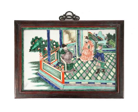 A Chinese porcelain famille verte panel, depicting a historical story, a warrior bringing news to two dignitaries, within a y