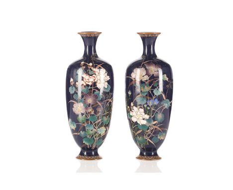 A pair of Japanese Meiji period cloisonné vases, with floral decoration in polychrome enamels, on a deep blue ground, 24.5 cm
