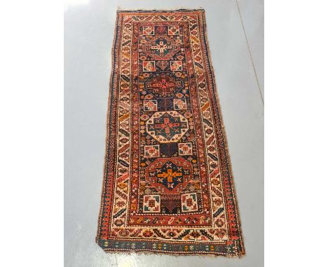 An indigo blue ground Karachov Kazak long rug, first half of the 20th century, with four geometric lozenges within an arrow h