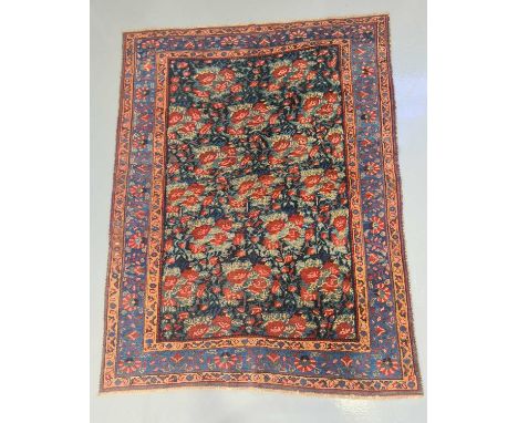 A dark blue ground Bidjar rug, 20th century, with "Gul Ferrangi" all-over pattern, within a stylized floral border. 190 cm x 