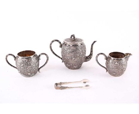 A Chinese three piece silver teaset by Wang Hing, late Qing, each piece of barrel form, the teapot repousse with a cockerel a