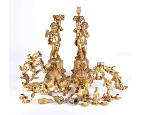 A pair of large French 19th century figural bronze candelabras, in the form of cherubs on a column pedestal plinth, (currentl