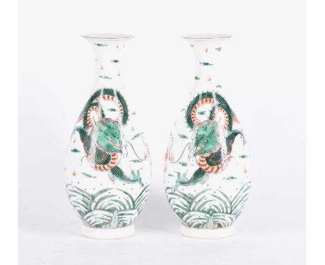 A pair of Chinese famille verte vases, painted with a dragon chasing a filming pearl amongst clouds, above spuming waves and 