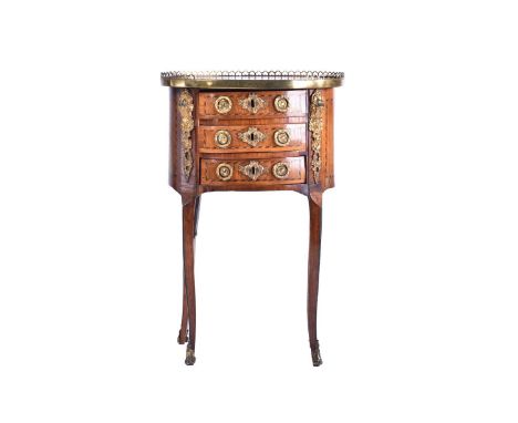 A Louis XVI satinwood and tulipwood Table en Chiffonier of oval section with pierced gallery top above a bank of three short 