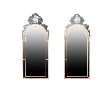 A pair of unusual bevel-edged and partial gilt-framed armorial pier-glass, English early 18th century, the shaped cresting be