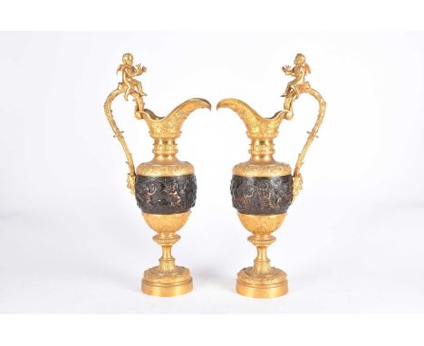 A pair of renaissance revival bronze and fire gilt ewers, after Claude Michel Clodion, 20th century, the handle surmounted by