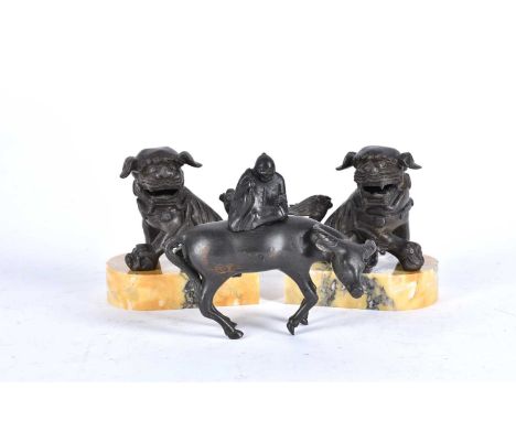 A Chinese bronze figure of a man upon a water buffalo, Qing, 18th/19th century, 15.5cm high; and a pair of Chinese bronze sea