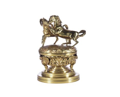 A mid 19th century gilt bronze oversized desk inkwell, the cover with two fighting wild horses, the base with applied winged 